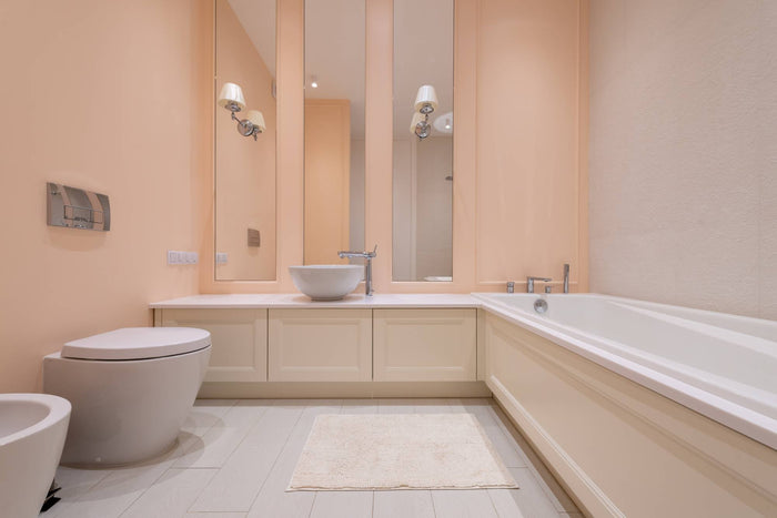 In which setting do you wash bath rugs